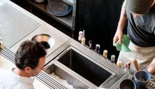 Aerial view of a man ordering a drink at a bar