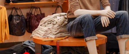 Mannequin sitting on a table in a clothing store