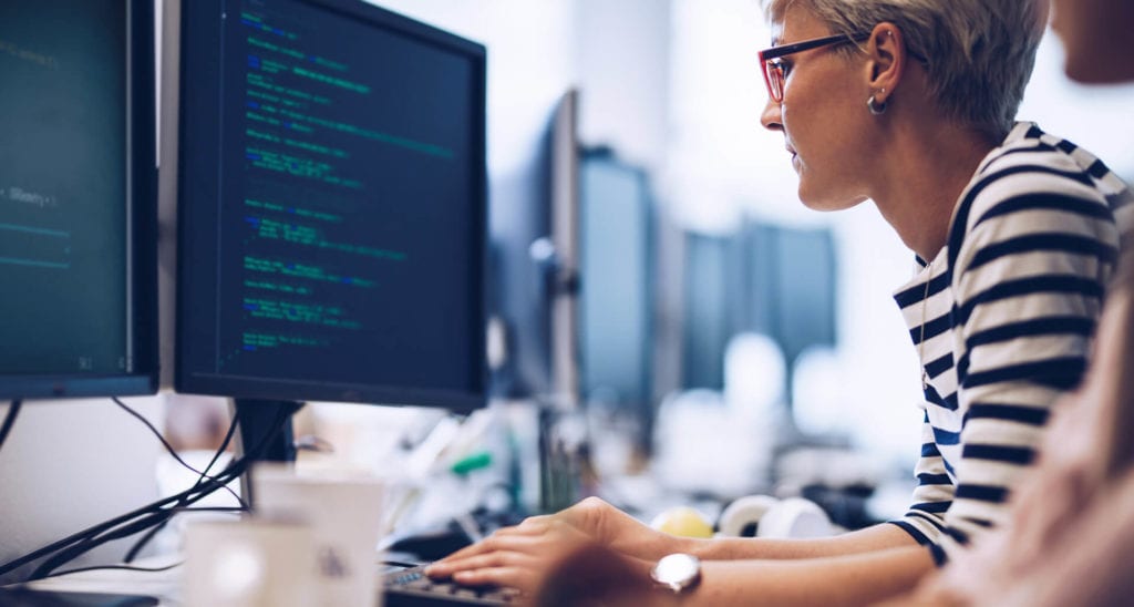 Female developer reading code on her computer