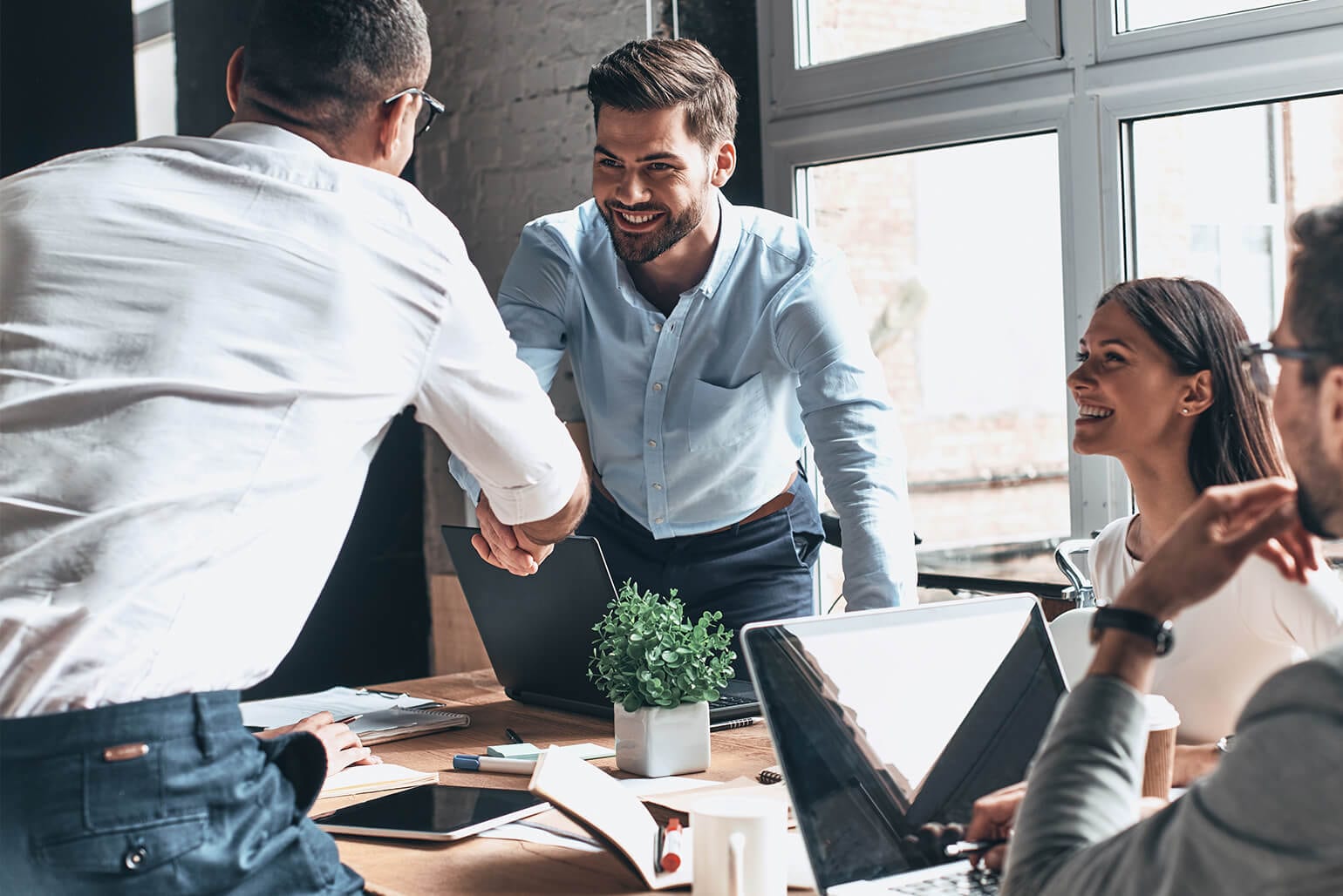 Two men shaking hands during a business meeting