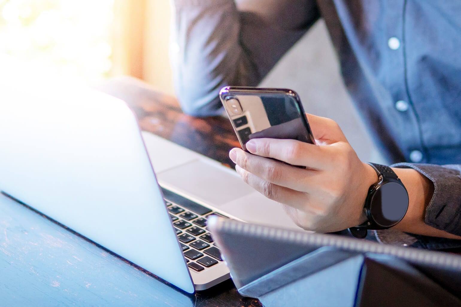 Male professional using a smartphone at his desk