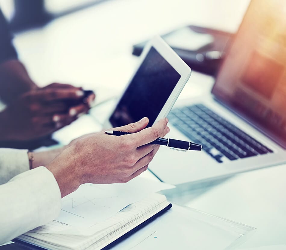 Close-up of two professionals looking at an iPad