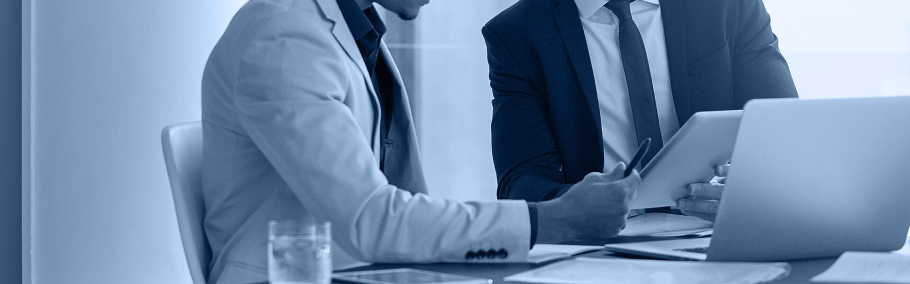 Two male business professionals meeting at a desk