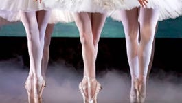 Three ballerinas dancing on pointe