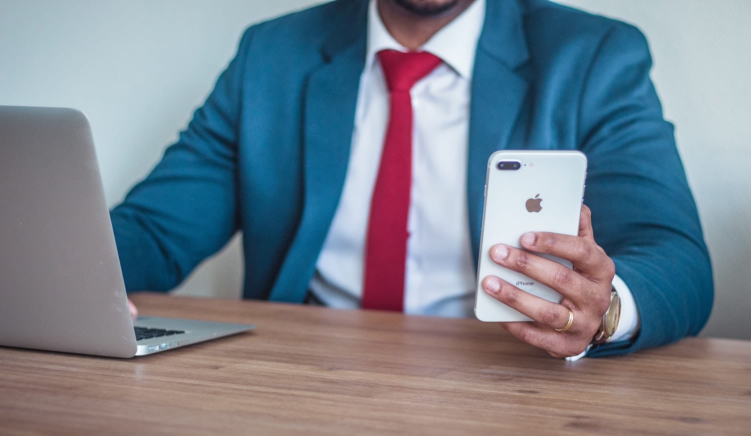 man in suit holding phone