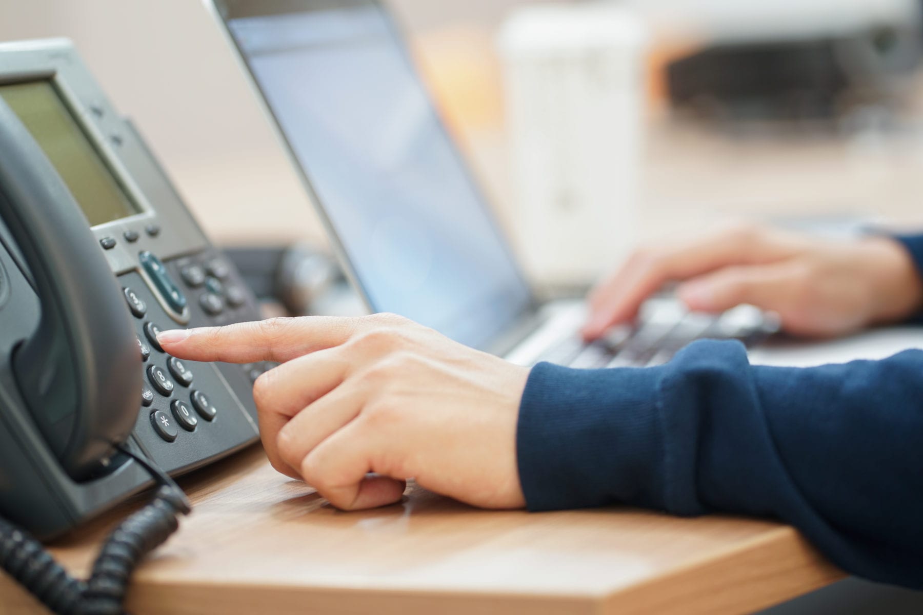 employee-man-hand-press-number-on-telephone-for-contact-with-someone