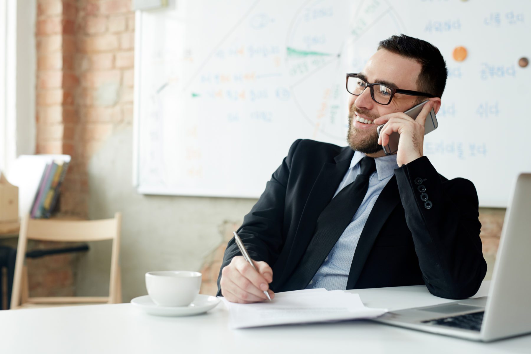 man laughing in phone call