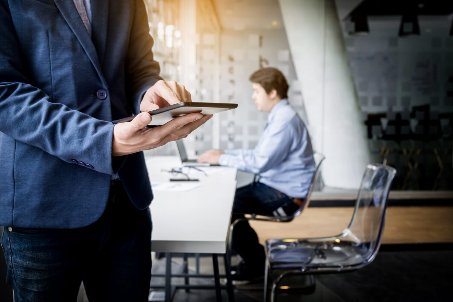 Businessman working with tablet in office, closeup.