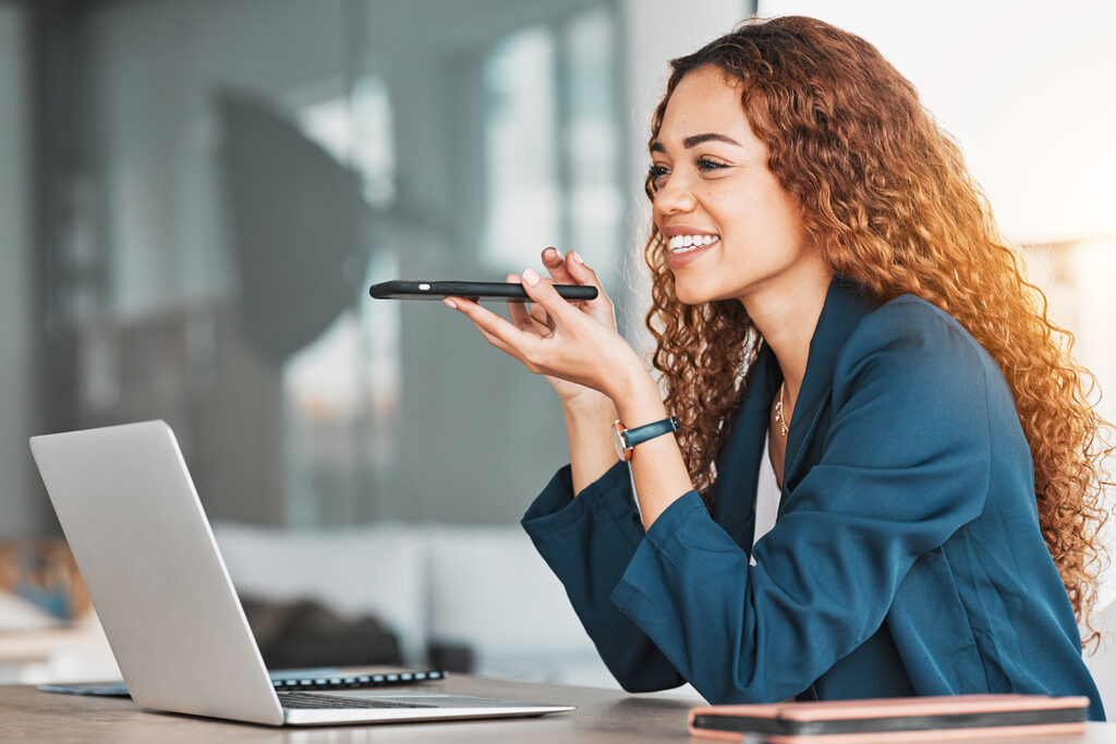 woman_talking_on_phone_in_front_of_laptop