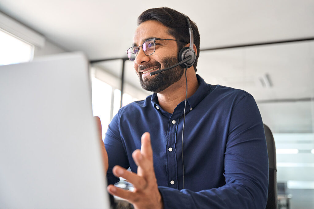 man-with-headset-talking-with-laptop