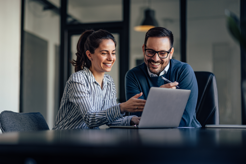 co-workers-looking-at-computer-screen-at-desk