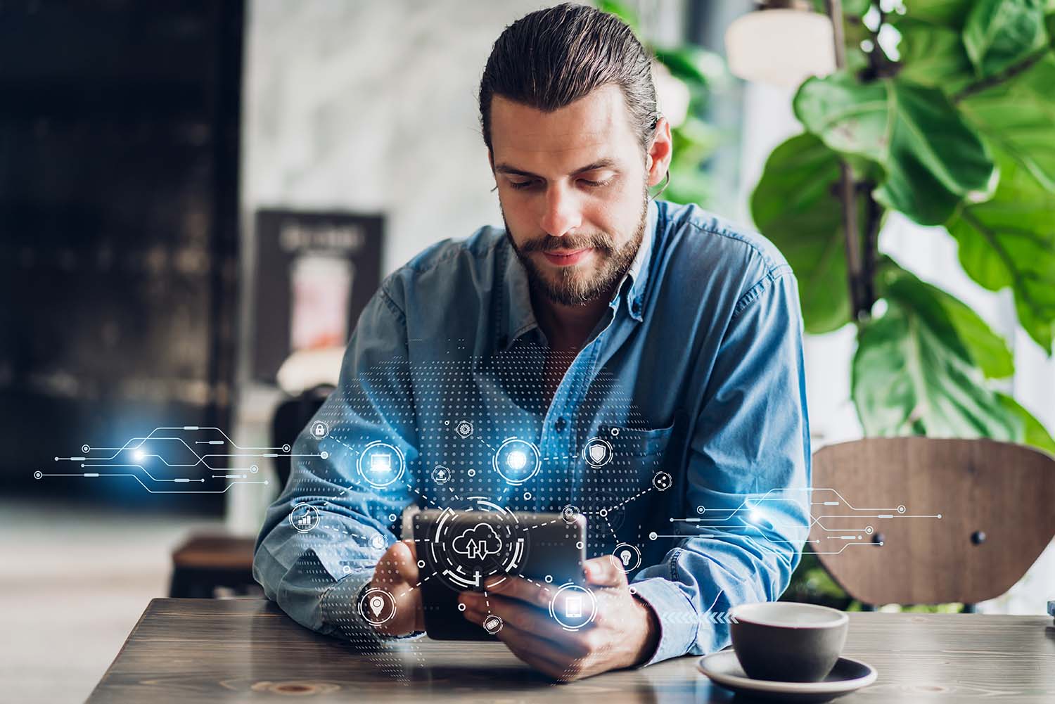 man-at-desk-holding-phone-with-icon-overlay