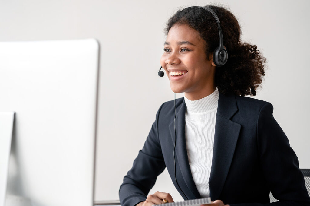 woman-with-headset-in-front-of-computer